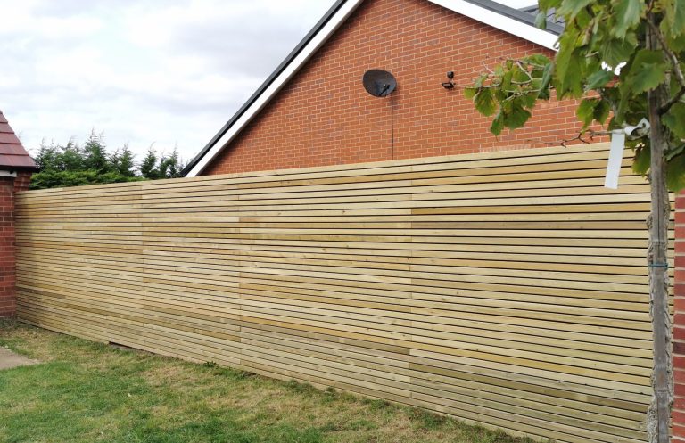 Wooden fence with horizontal slats installed by Nu-Bourne Landscapes in Saffron Walden